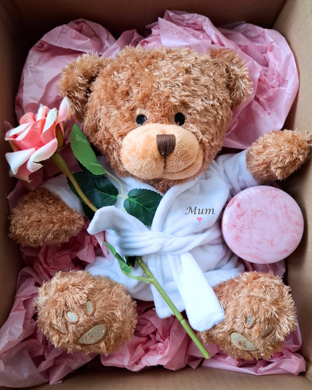 Tissue wrapped gift presentation inside a box with thank you card